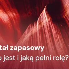 Kapitał zapasowy: budowanie bezpieczeństwa finansowego. Tekst na tle czerwonych, skalnych formacji.